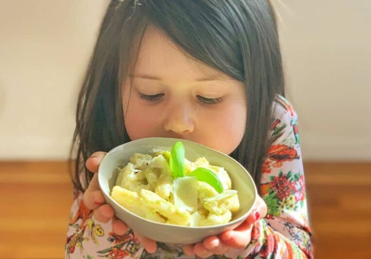 young child with bowl of pasta